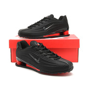 Black and red Nike Shox Z R2 sneakers displayed on a red shoe box