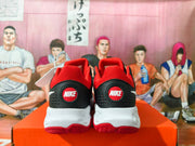 Rear view of black and red Nike sneakers showing heel branding, white midsoles, and red outsoles.