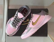 Pair of pink, silver and gold Nike Kobe 5 basketball shoes displayed over a black shoebox.