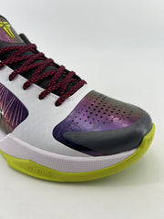 Close-up of the purple perforated toe, dark toe bumper, and green outsole.