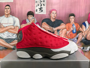 Side profile highlighting the red textured upper, gray and black midsole, and segmented outsole.