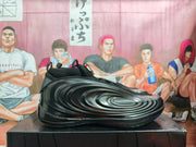 Side profile of a black sneaker showing its sculpted wave-like panels