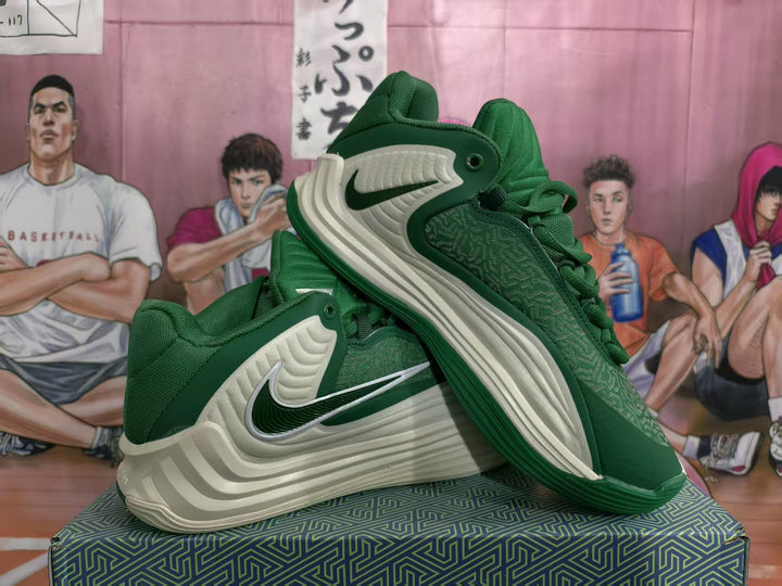 Pair of green and cream Nike basketball sneakers shown from an angled side view.