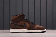 Side profile showing the mid-top shape, layered brown panels, black Swoosh, and white midsole.
