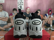 Heel view of white and black Nike sneakers