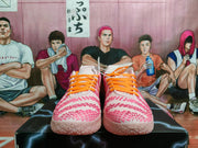 Front view of the pair showing orange laces, pink textured upper detailing, and pale pink soles.