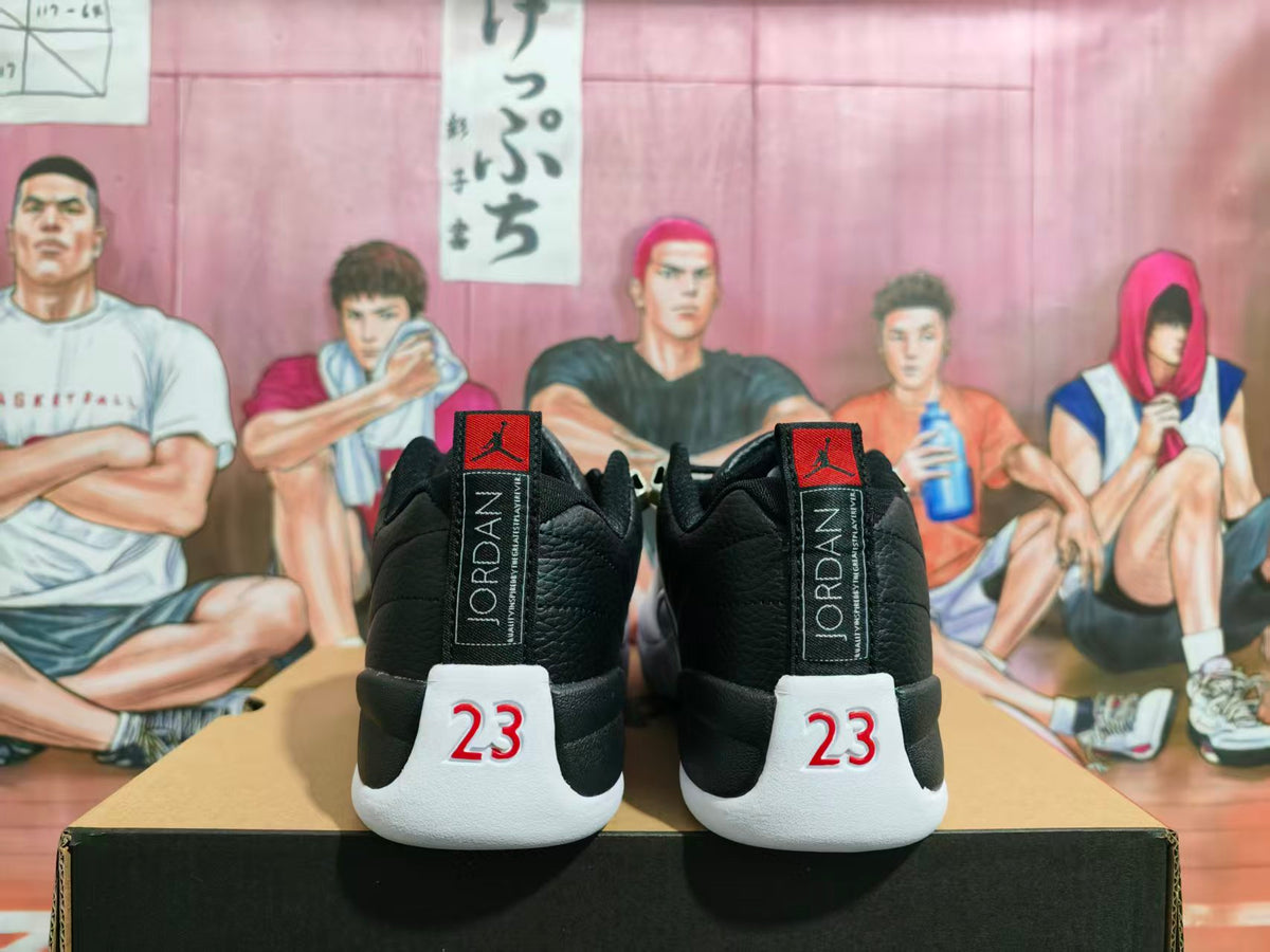 Rear view of black and white Jordan Jumpman sneakers showing vertical Jordan branding and red 23 heel details.
