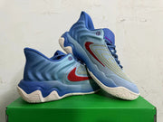 Pair of blue Nike high-top sneakers showing the red swoosh, curved detailing, and textured outsoles