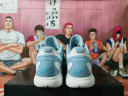 Rear view showing padded gray collars, translucent blue heel panels, white midsoles, and blue signature-style graphics.