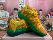 Side view showing the yellow upper, sculpted side detailing, green midsole, and dark outsole.