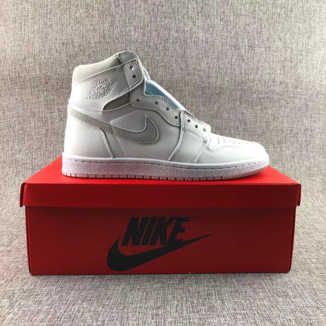 White and grey high-top sneaker displayed on a red shoe box.