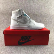 White and grey high-top sneaker displayed on a red shoe box.