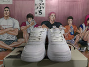 Front view of white Nike sneakers with tonal laces, perforated toe panels, and padded collars.