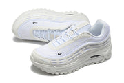 Angled view of white lace-up Nike sneakers showing the textured upper and side panels.