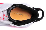 Top-down view into the sneaker showing the black padded collar, orange footbed, and interior printed number.
