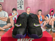 Front view of black Nike high-top sneakers showing purple and neon yellow Swoosh accents and purple outsole sections.