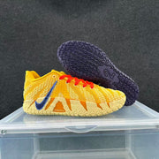 Golden yellow and cream shoe beside the patterned outsole of the lavender and navy shoe
