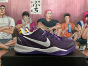 Side view of a purple basketball shoe with a white Nike logo and white midsole