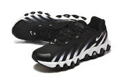 Angled side view of black Nike sneakers with white accents and a sculpted sole.