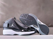 Sneakers displayed with the dark patterned outsoles visible