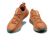 Warm orange Nike LeBron TR1 shoes with teal outsole accents, front view