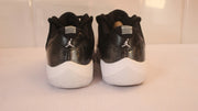 Rear view showing Jordan heel logos, black uppers and white outsoles.