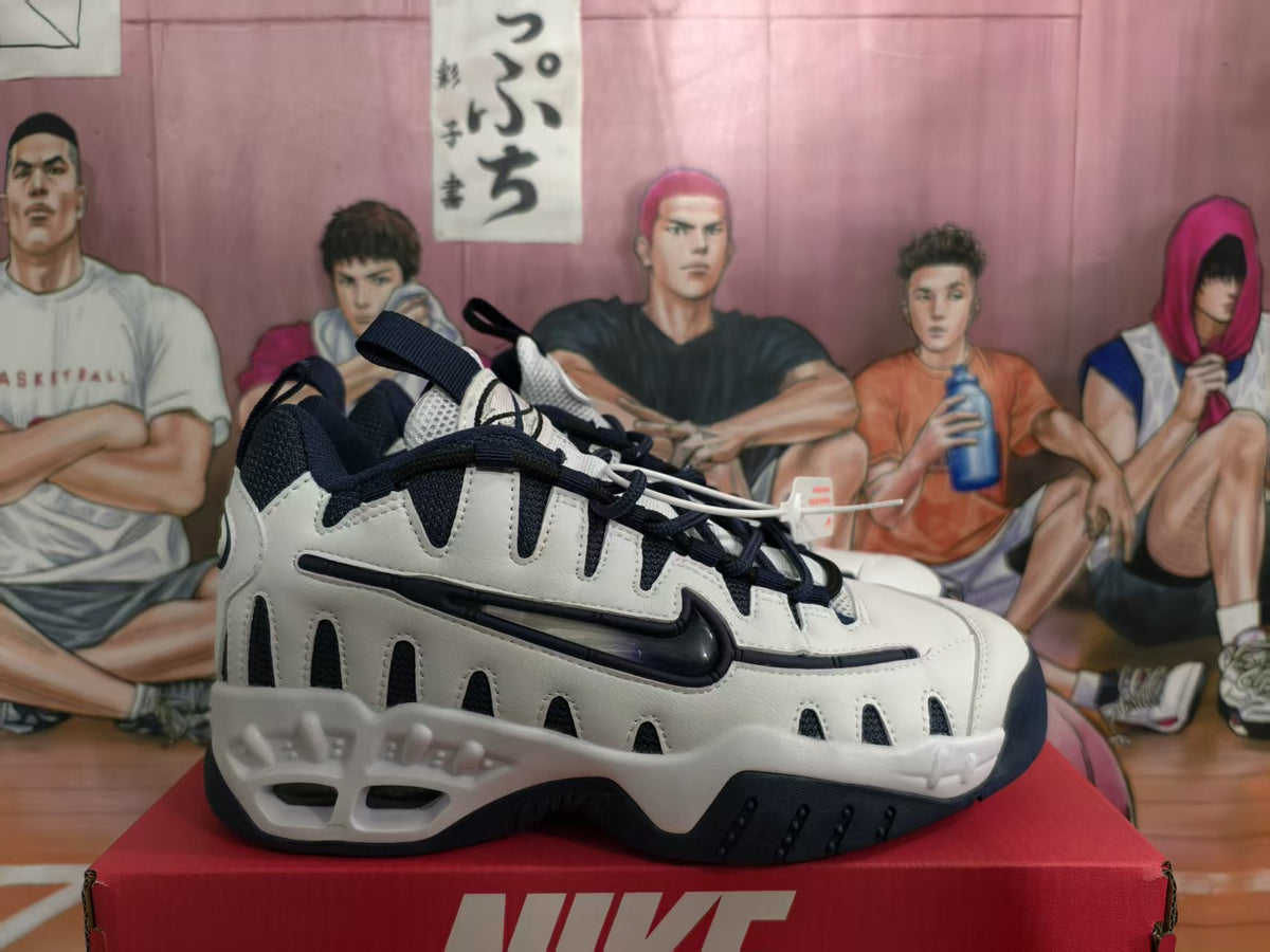 White and navy Nike sneakers shown from the side