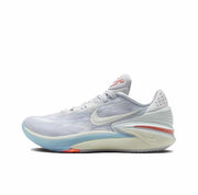 White and pale gray Nike GT Cut 2 sneaker with a light Swoosh, blue outsole edge, and red heel accent.