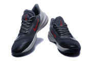 Pair of Nike Precision 7 shoes shown from the front, highlighting red side and tongue accents.