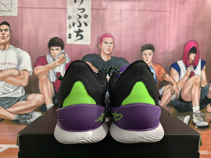 Rear view of black basketball sneakers with bright green heel panels, purple heel sections and white outsoles.