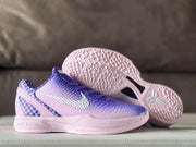Nike Kobe 6 sneakers displayed with one shoe lifted to show the pink outsole traction pattern and Kobe emblem.