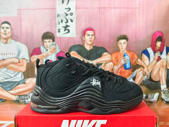 Black high-cut Nike basketball sneaker shown from the side on a red box.