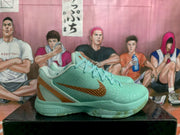 Side view showing the mint green textured upper, brown-gold Swoosh detail and molded sole.