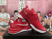 Angled view of a pair of red Nike sneakers displaying the side swoosh, laces, padded collar, and outsole.
