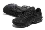 Angled views of black Nike Air Max Plus TN-style sneakers showing the lace-up upper and layered side cage.