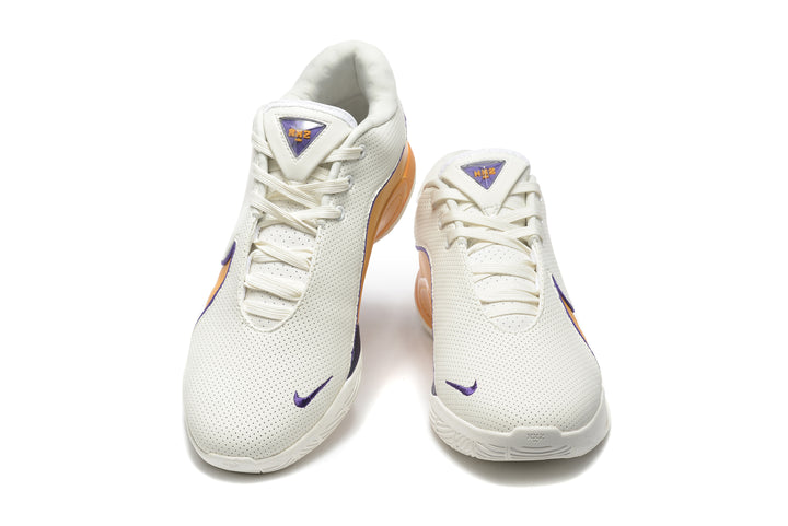 Pair of white Nike sneakers shown from the front, with purple accents and gold-orange side panels.