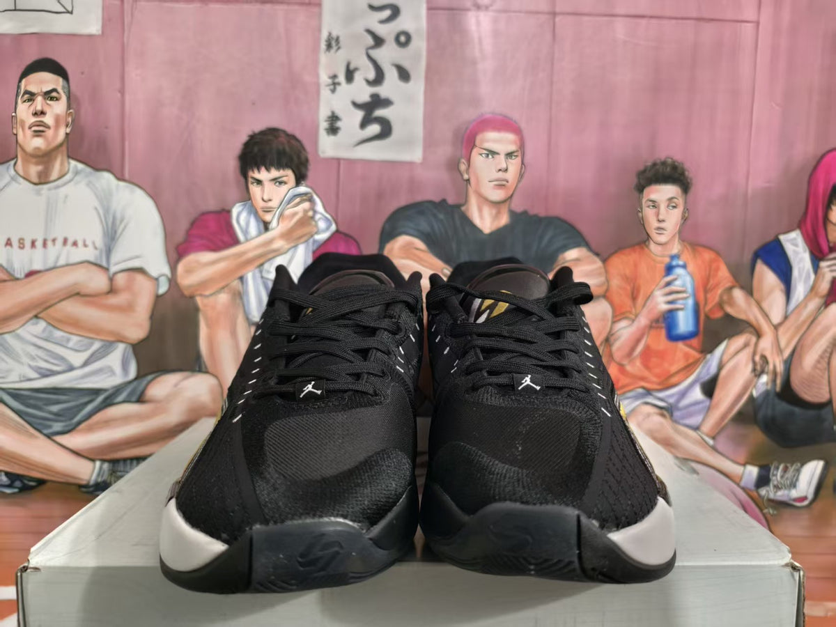 Front view of black basketball sneakers with white midsoles and small Jumpman logos.