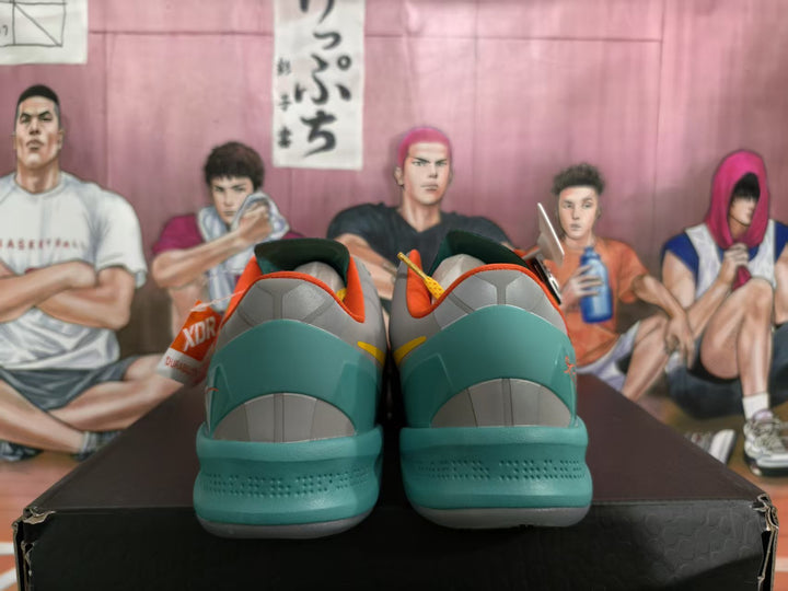 Rear view of multicolor Nike basketball sneakers showing teal heel panels, gray heel details, and orange collar accents.
