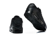 Rear and outsole views of black Nike Air Max 90 sneakers.