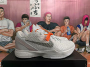 Side profile of a white and silver Nike basketball sneaker showing textured detailing, a side swoosh, and a sculpted midsole.