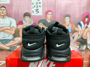 Rear view of black Nike basketball sneakers with white heel Swooshes and visible heel Air units