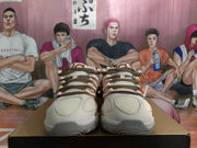 Front view of the pair showing the mesh toe panels, brown laces, and gray outsole