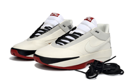 Pair of off-white Jordan 40 sneakers with black laces and red outsole accents.