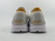 Rear view of the pair with white heel collars, gold-toned accents, and signature-style heel graphics
