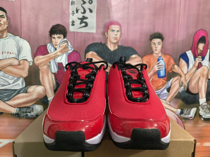 Front view of red Nike sneakers with black laces, white midsoles, and black toe details.