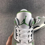 Top-down close-up of the white tongue with green Jumpman branding and white laces.