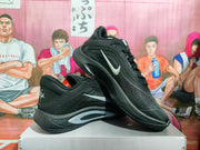 Angled view of paired black Nike basketball sneakers showing silver Swooshes, A'ja heel branding, and the sculpted midsoles.