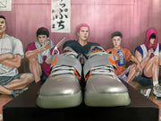Front view showing the gray laces, orange accents, and translucent-looking outsoles.