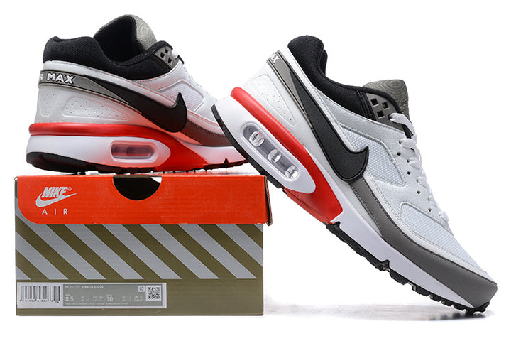 Nike Air Max sneakers in white, grey, black, and red, pictured with a shoe box.