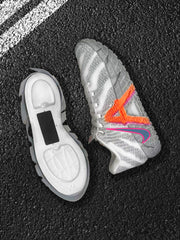 Side and outsole views of a grey Nike basketball sneaker with orange and pink branding details.